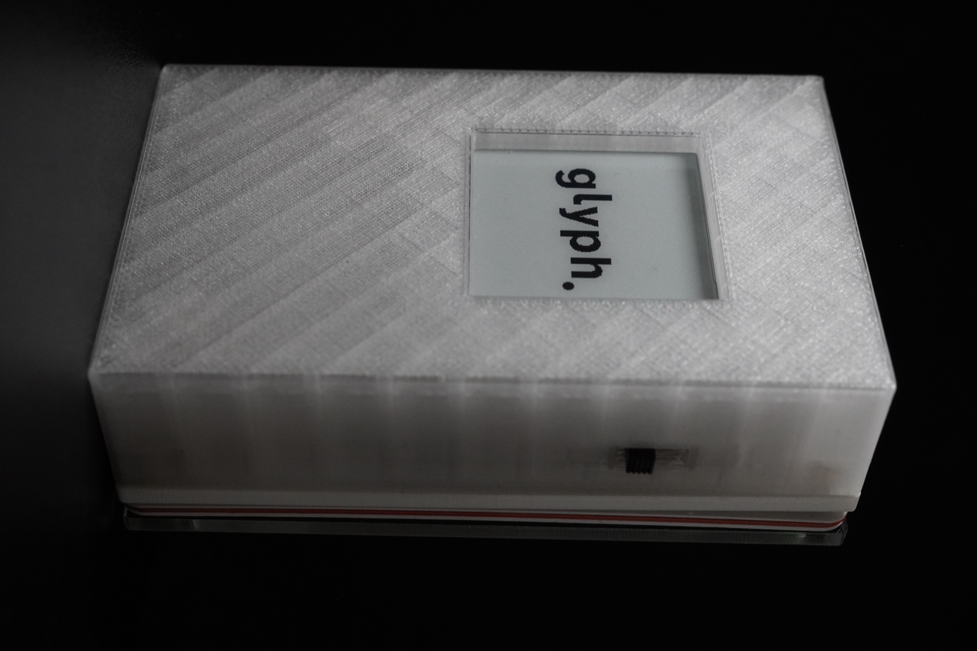 Front of the Glyph wallet, e-ink display showing the glyph wordmark